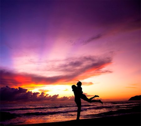 Silhouette of happy  couple embracing on the beach Stock Photo - Budget Royalty-Free & Subscription, Code: 400-05755411