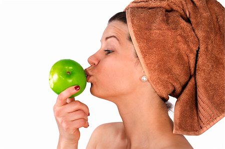 Beautiful young woman after bath with a towel on her head and an apple in her hand. Over white. Not isolated. Stock Photo - Budget Royalty-Free & Subscription, Code: 400-05755497
