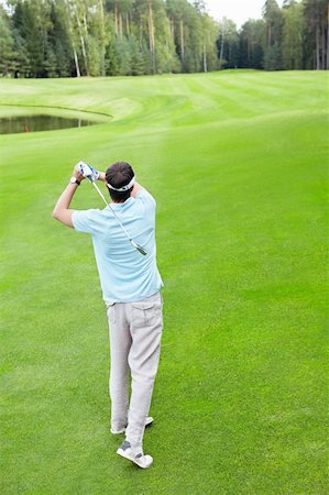 simsearch:400-05748591,k - A young man with a golf club outdoors Stock Photo - Budget Royalty-Free & Subscription, Code: 400-05755687