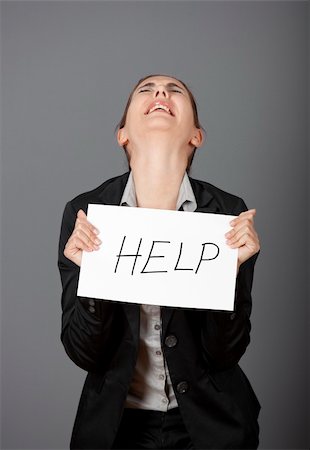 simsearch:400-04343341,k - Stressed business woman imploring for help, holding a cardboard with the message "Help" Foto de stock - Super Valor sin royalties y Suscripción, Código: 400-05750496