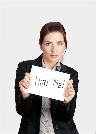 simsearch:400-04648812,k - Business woman holding a card board with the text message "Hire me". Stock Photo - Budget Royalty-Free & Subscription, Code: 400-05750491