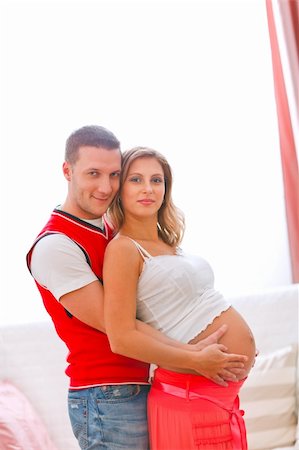 Portrait of young pregnant woman with husband hugging her tummy Stock Photo - Budget Royalty-Free & Subscription, Code: 400-05750819