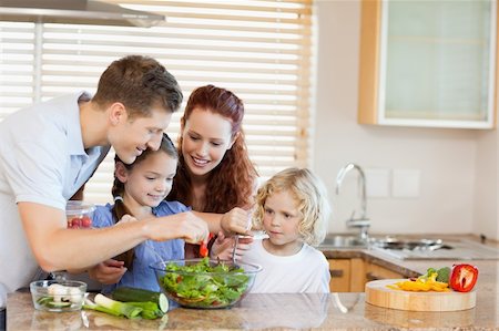 simsearch:6109-06194424,k - Young family preparing salad together Stock Photo - Budget Royalty-Free & Subscription, Code: 400-05751185
