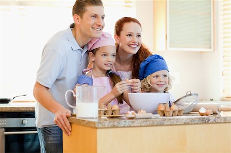 Happy family in the kitchen with baking ingredients Stock Photo - Budget Royalty-Free & Subscription, Code: 400-05751229