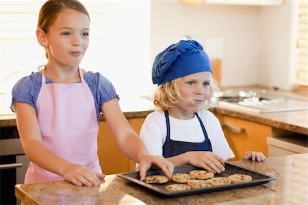 simsearch:400-05749768,k - Happy siblings enjoying cookies together Stock Photo - Budget Royalty-Free & Subscription, Code: 400-05751237