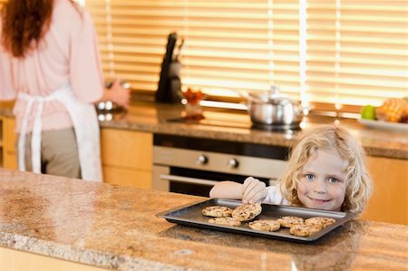 simsearch:400-05749772,k - boy stealing a cookie while is mother is not watching Stock Photo - Budget Royalty-Free & Subscription, Code: 400-05751246