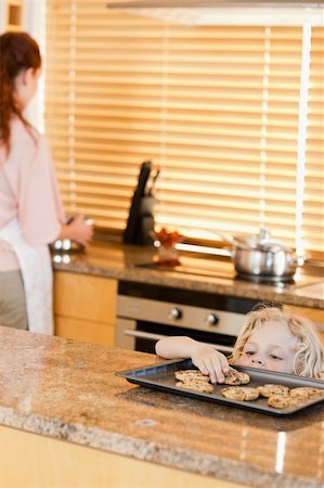 simsearch:400-05749772,k - Sneaky boy stealing cookies from the kitchen counter Stock Photo - Budget Royalty-Free & Subscription, Code: 400-05751248