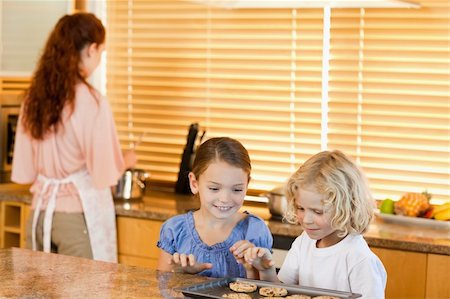 simsearch:400-05749768,k - Young siblings stealing cookies together Stock Photo - Budget Royalty-Free & Subscription, Code: 400-05751249
