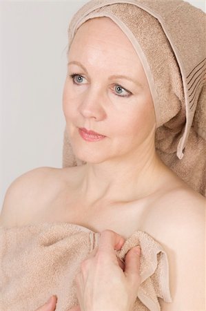Adult beautiful woman after bath with a towel on her head. Over white. Not isolated. Stock Photo - Budget Royalty-Free & Subscription, Code: 400-05751450