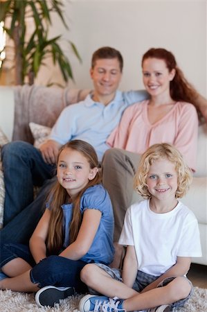 Happy young family sitting in the living room Stock Photo - Budget Royalty-Free & Subscription, Code: 400-05751507