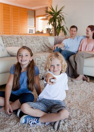 simsearch:400-05897773,k - Family watching television in the living room together Stock Photo - Budget Royalty-Free & Subscription, Code: 400-05751509