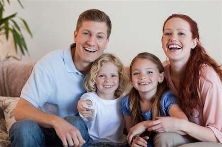 Young family watching a funny movie Stock Photo - Budget Royalty-Free & Subscription, Code: 400-05751503