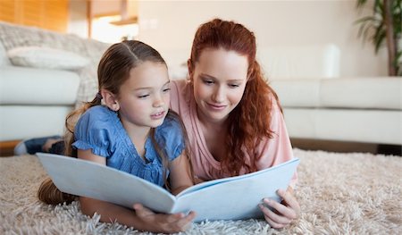 simsearch:400-05751566,k - Mother and daughter looking at a magazine together Stock Photo - Budget Royalty-Free & Subscription, Code: 400-05751545