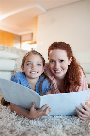simsearch:400-05751566,k - Mother and daughter together with magazine on the floor Stock Photo - Budget Royalty-Free & Subscription, Code: 400-05751547
