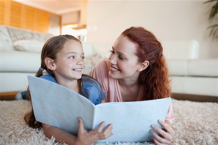 simsearch:400-05751566,k - Mother and daughter together with periodical on the floor Stock Photo - Budget Royalty-Free & Subscription, Code: 400-05751548