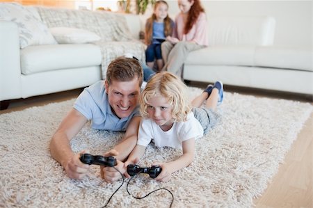 Father and son playing video games together Stock Photo - Budget Royalty-Free & Subscription, Code: 400-05751542