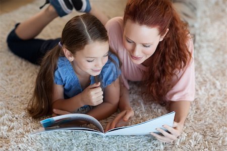 simsearch:400-05751566,k - Mother and daughter on the carpet reading together Stock Photo - Budget Royalty-Free & Subscription, Code: 400-05751550
