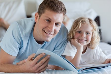 simsearch:400-05751566,k - Father and son looking at magazine together Stock Photo - Budget Royalty-Free & Subscription, Code: 400-05751566