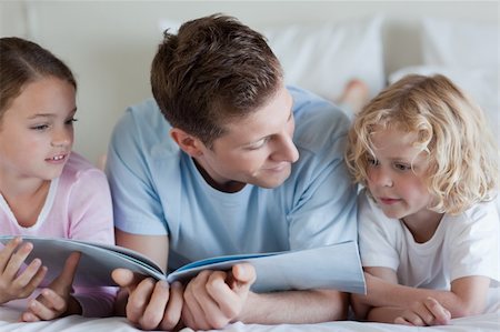 simsearch:400-05751566,k - Father reading together with his children Stock Photo - Budget Royalty-Free & Subscription, Code: 400-05751569
