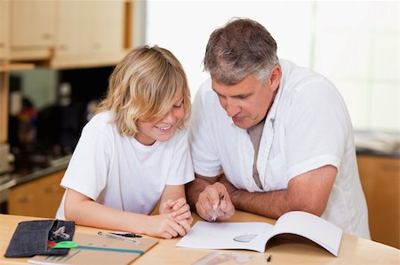 simsearch:400-05751676,k - Father helping son with his homework Stock Photo - Budget Royalty-Free & Subscription, Code: 400-05751655