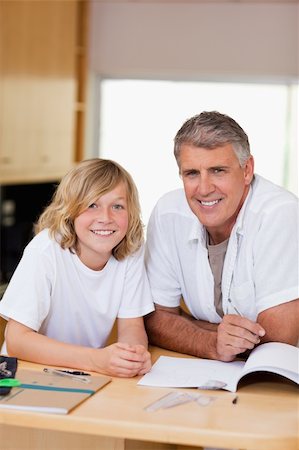 simsearch:400-05751679,k - Father and son doing homework together Stock Photo - Budget Royalty-Free & Subscription, Code: 400-05751656