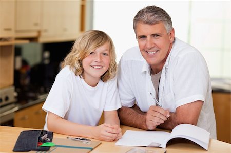 Man helping his son with his homework Foto de stock - Royalty-Free Super Valor e Assinatura, Número: 400-05751657