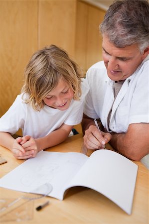 simsearch:400-05751679,k - Man explaining homework to his son Stock Photo - Budget Royalty-Free & Subscription, Code: 400-05751658