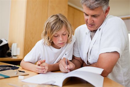 simsearch:400-05751676,k - Boy gets help help with homework from father Stock Photo - Budget Royalty-Free & Subscription, Code: 400-05751659