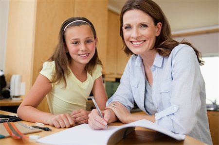 simsearch:400-05751679,k - Mother and daughter doing homework together Stock Photo - Budget Royalty-Free & Subscription, Code: 400-05751664