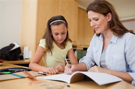 simsearch:400-05751679,k - Mother helping her daughter with her homework Stock Photo - Budget Royalty-Free & Subscription, Code: 400-05751666