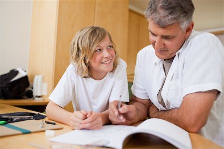 simsearch:400-05751676,k - Boy doing homework together with his father Stock Photo - Budget Royalty-Free & Subscription, Code: 400-05751660