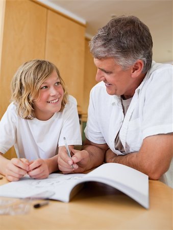 simsearch:400-05751676,k - Male helping his son with homework Stock Photo - Budget Royalty-Free & Subscription, Code: 400-05751661