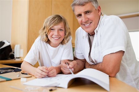 simsearch:400-05751679,k - Father helping his son with his homework Stock Photo - Budget Royalty-Free & Subscription, Code: 400-05751662