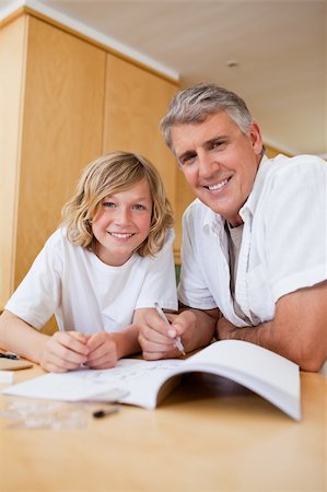simsearch:400-05751676,k - Boy getting help with his homework from father Stock Photo - Budget Royalty-Free & Subscription, Code: 400-05751663