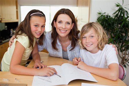 simsearch:400-05751679,k - Mother helping her children with their homework Stock Photo - Budget Royalty-Free & Subscription, Code: 400-05751675