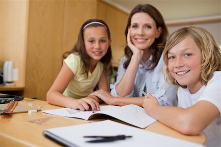 Mother doing homework with her children Foto de stock - Royalty-Free Super Valor e Assinatura, Número: 400-05751677