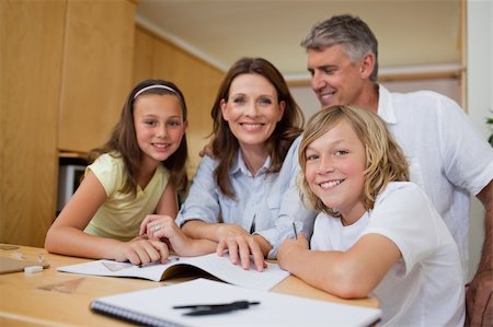 simsearch:400-05751679,k - Parents helping their children with homework Stock Photo - Budget Royalty-Free & Subscription, Code: 400-05751678