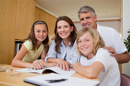 simsearch:400-05751679,k - Parents helping their children with their homework Stock Photo - Budget Royalty-Free & Subscription, Code: 400-05751679