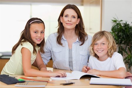 simsearch:400-05751676,k - Woman helping her children with their homework Stock Photo - Budget Royalty-Free & Subscription, Code: 400-05751673