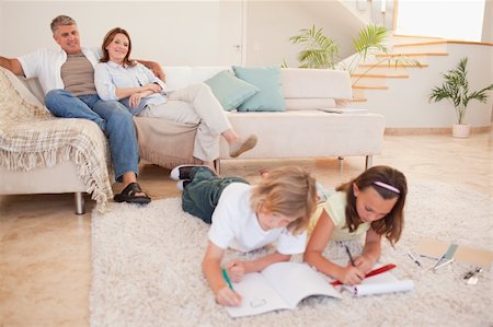 simsearch:400-05751676,k - Children doing homework with their parents behind them Stock Photo - Budget Royalty-Free & Subscription, Code: 400-05751687