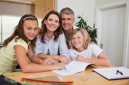 simsearch:400-05751679,k - Family doing homework together Stock Photo - Budget Royalty-Free & Subscription, Code: 400-05751680