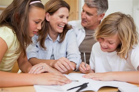 simsearch:400-05751676,k - Siblings getting help with homework from their parents Stock Photo - Budget Royalty-Free & Subscription, Code: 400-05751682