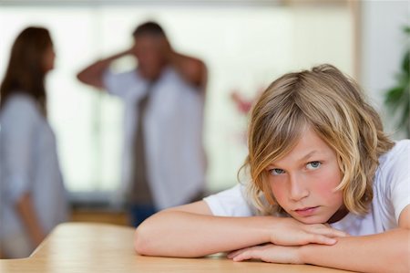 divorced family - Sad looking boy with his arguing parents behind him Stock Photo - Budget Royalty-Free & Subscription, Code: 400-05751694