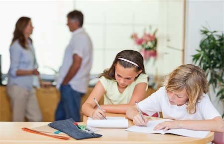 simsearch:400-05751676,k - Siblings doing homework with their parents behind them Stock Photo - Budget Royalty-Free & Subscription, Code: 400-05751710