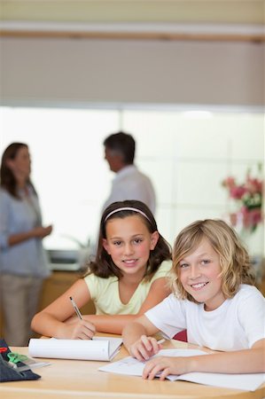 simsearch:400-05751679,k - Children doing their homework with their parents behind them Stock Photo - Budget Royalty-Free & Subscription, Code: 400-05751713