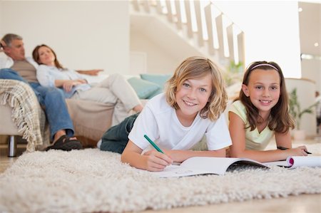 simsearch:400-05751676,k - Brother and sister doing their homework on the floor Stock Photo - Budget Royalty-Free & Subscription, Code: 400-05751854