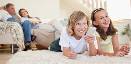 simsearch:400-05897773,k - Siblings lying on the floor watching tv together Stock Photo - Budget Royalty-Free & Subscription, Code: 400-05751858
