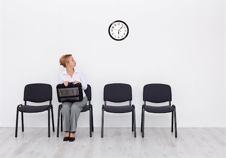 Still waiting for the job interview - woman checking time Stock Photo - Budget Royalty-Free & Subscription, Code: 400-05752340