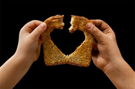 simsearch:400-05701644,k - Sharing food with love - kids hands breaking a slice of bread Stock Photo - Budget Royalty-Free & Subscription, Code: 400-05752352