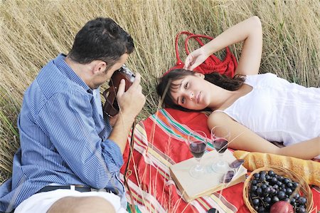 happy young couple enjoying  picnic on the countryside in the field  and have good time Stock Photo - Budget Royalty-Free & Subscription, Code: 400-05875214